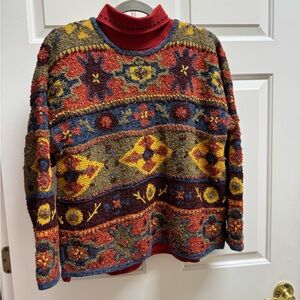 Susan Bristol Colorful Knit Sweater with Floral Design and turtleneck.